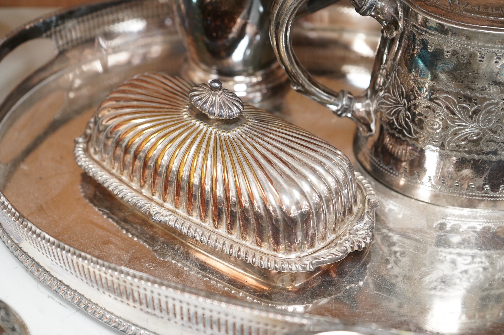 A quantity of plated wares to include a galleried tray, teapot, jug and bon bon dish with glass liner, largest 45cm wide